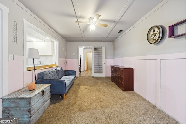 living area featuring ceiling fan and light colored carpet