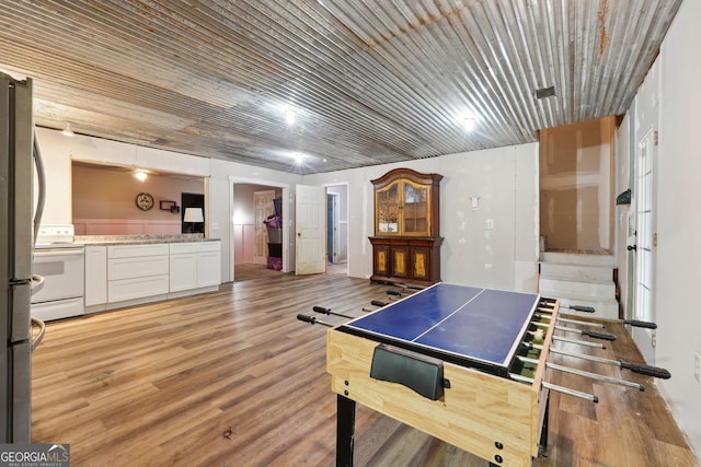 rec room with light hardwood / wood-style flooring and wooden ceiling