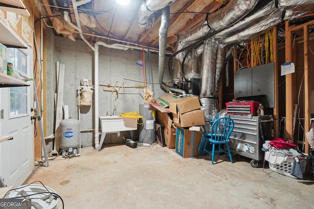 basement featuring water heater and sink