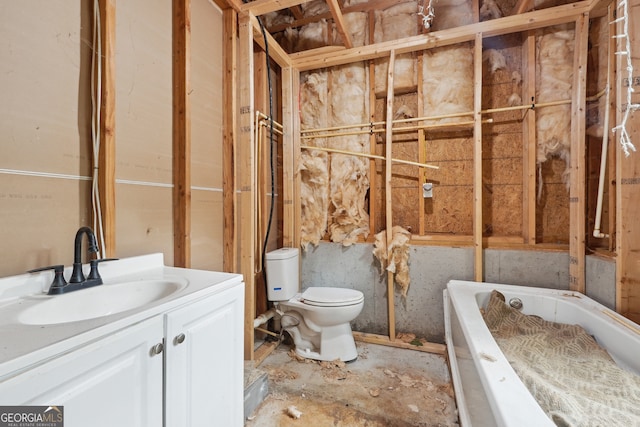 bathroom with vanity, toilet, and a bath