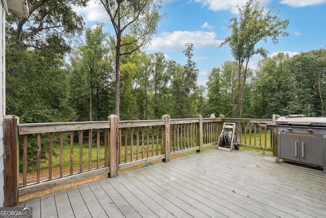 wooden terrace with a grill