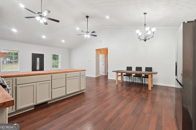 kitchen with a textured ceiling, vaulted ceiling, dark hardwood / wood-style floors, and ceiling fan with notable chandelier