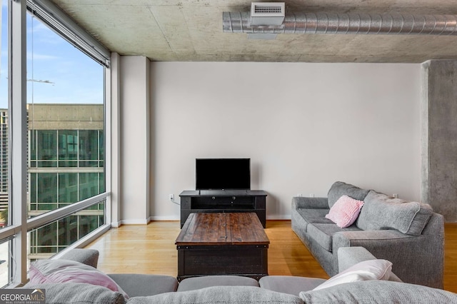 living room with plenty of natural light and hardwood / wood-style floors