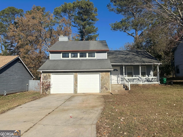 view of front of home with a front yard, a porch, and a garage