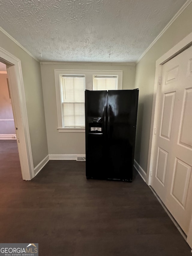 interior space with wood-type flooring, ornamental molding, a textured ceiling, and black refrigerator with ice dispenser