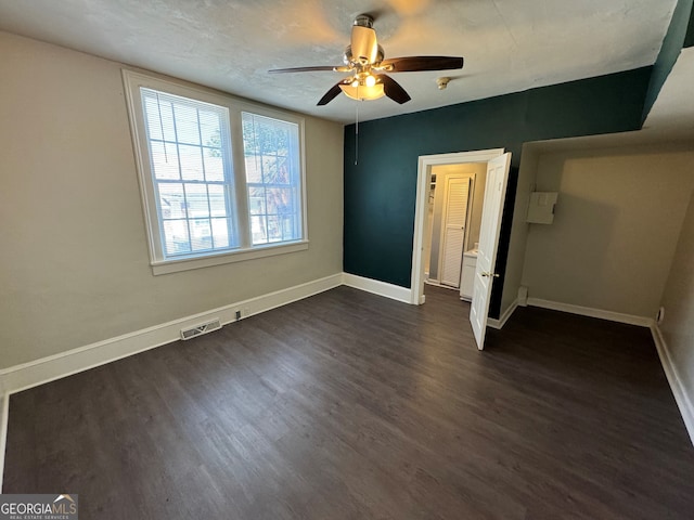 unfurnished bedroom featuring ceiling fan and dark hardwood / wood-style floors