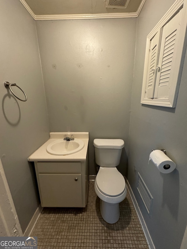 bathroom featuring crown molding, vanity, and toilet