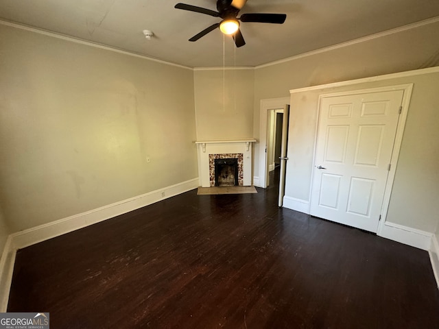 unfurnished living room with dark wood-type flooring, ceiling fan, a fireplace, and ornamental molding