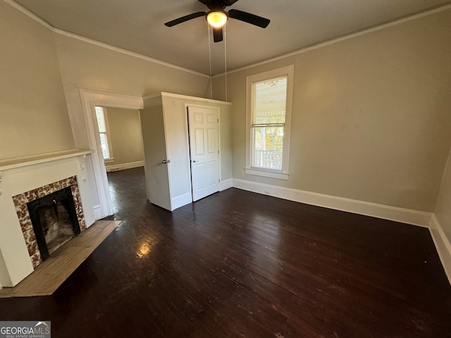 unfurnished living room with dark wood-type flooring, ceiling fan, and crown molding