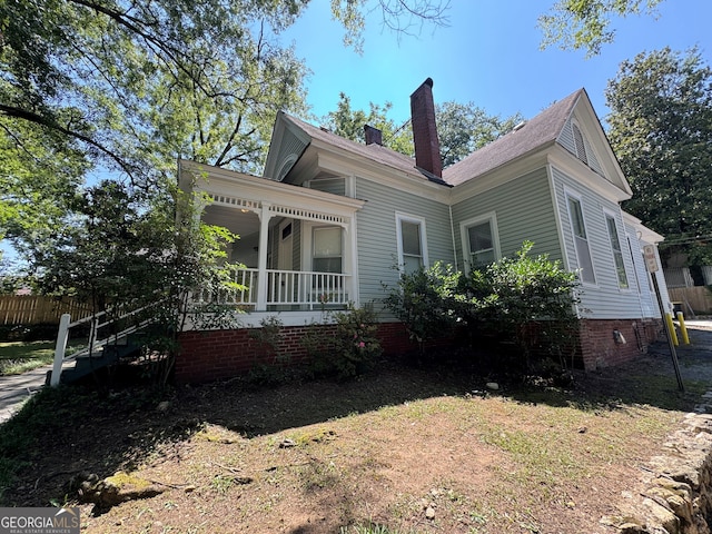 view of side of property with a porch