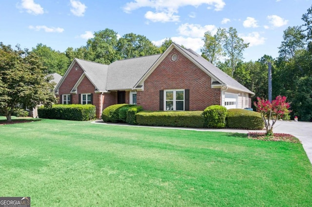 view of front of house with a front yard and a garage