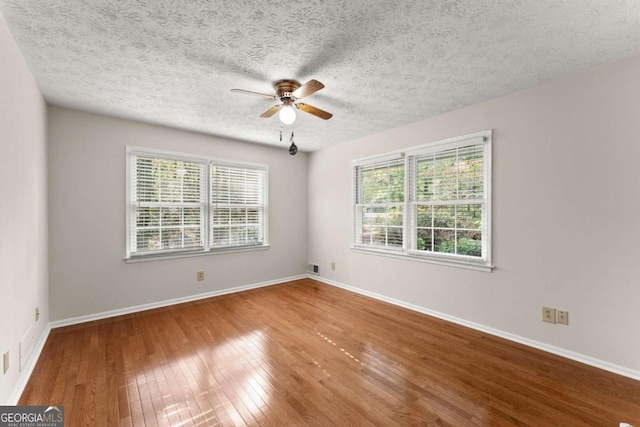 5775 Lakeshore Dr, Buford, GA 30518 - empty room with ceiling fan, wood-type flooring, baseboards, and a textured ceiling