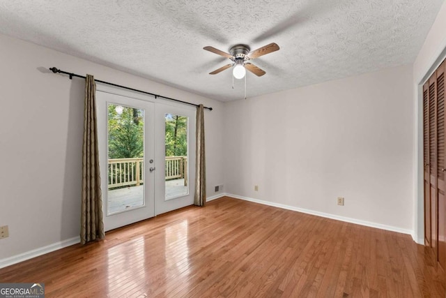 5775 Lakeshore Dr, Buford, GA 30518 - spare room featuring french doors, ceiling fan, light wood-style floors, a textured ceiling, and baseboards