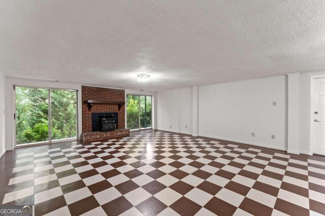 unfurnished living room featuring a fireplace and a textured ceiling