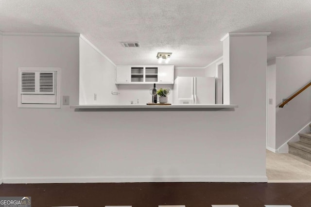5775 Lakeshore Dr, Buford, GA 30518 - kitchen with white fridge with ice dispenser, baseboards, ornamental molding, a textured ceiling, and open shelves