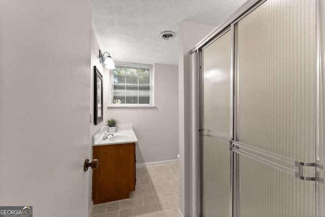 5775 Lakeshore Dr, Buford, GA 30518 - full bathroom featuring a shower stall, baseboards, vanity, a textured ceiling, and tile patterned floors