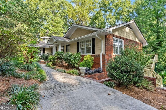 5775 Lakeshore Dr, Buford, GA 30518 - view of front facade featuring stairs and brick siding