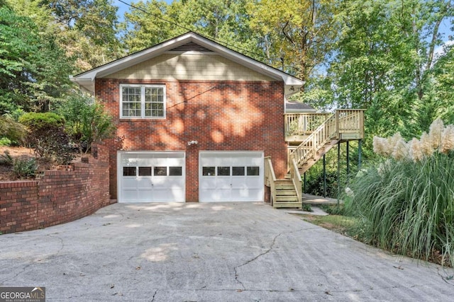 5775 Lakeshore Dr, Buford, GA 30518 - view of side of home with stairs, driveway, a garage, brick siding, and a deck