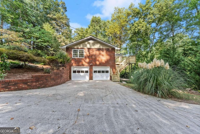 5775 Lakeshore Dr, Buford, GA 30518 - view of home's exterior with stairs, asphalt driveway, a garage, and brick siding