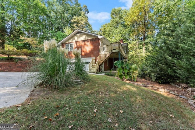 view of home's exterior with a yard and a wooden deck