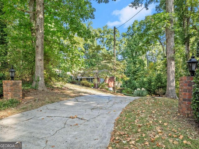 5775 Lakeshore Dr, Buford, GA 30518 - view of concrete driveway featuring street lights