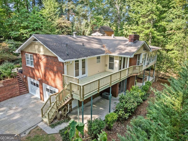 5775 Lakeshore Dr, Buford, GA 30518 - rear view of house featuring stairs, driveway, a shingled roof, a chimney, and a wooden deck