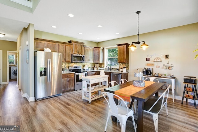 interior space featuring washer / clothes dryer, light hardwood / wood-style flooring, and sink