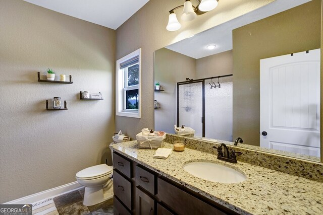 bathroom featuring an enclosed shower, toilet, and vanity