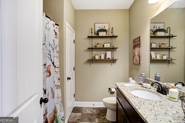 bathroom with vanity, toilet, and walk in shower