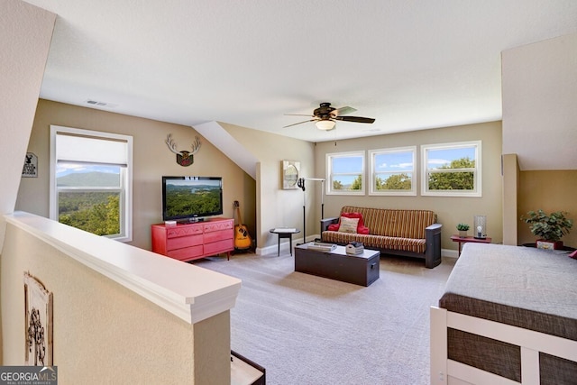 carpeted living room with lofted ceiling, ceiling fan, and a textured ceiling