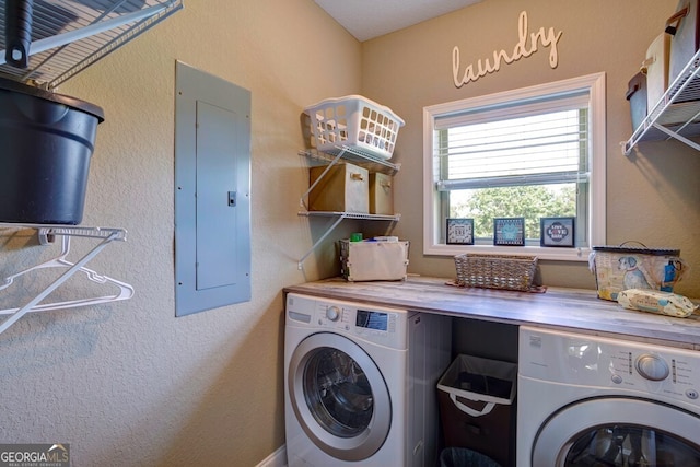 washroom with electric panel and separate washer and dryer