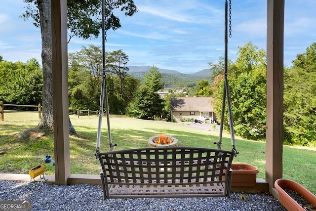 exterior space featuring a mountain view and a lawn