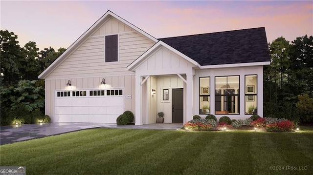 view of front of house featuring a yard and a garage