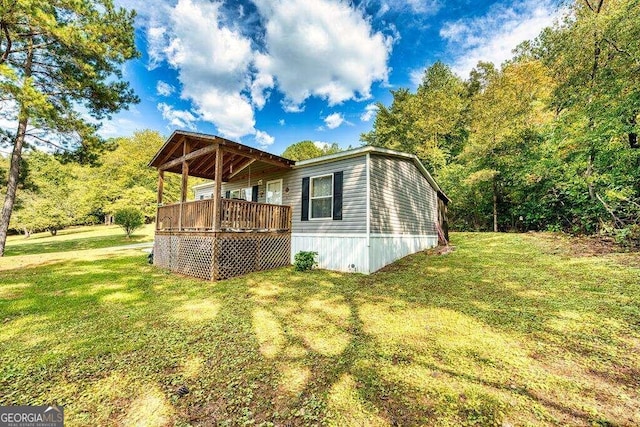 view of property exterior with a yard and a deck