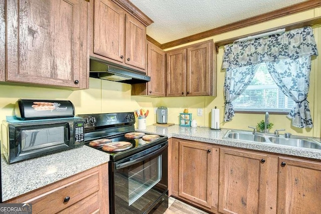 kitchen with black appliances, a textured ceiling, and sink