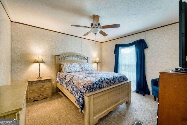 bedroom with crown molding, light colored carpet, ceiling fan, and a textured ceiling