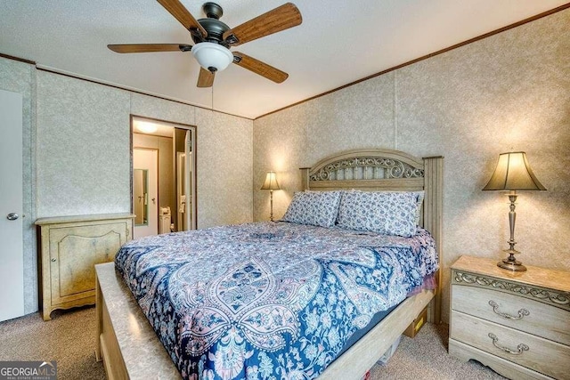 bedroom featuring a textured ceiling, light colored carpet, ceiling fan, and ornamental molding