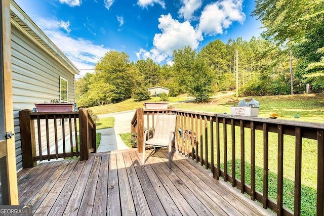 wooden terrace with a lawn