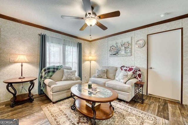 living room with a textured ceiling, ceiling fan, ornamental molding, and hardwood / wood-style floors