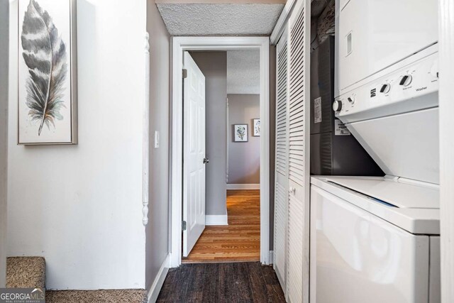 200 Villa Rd Unit 126, Jasper, GA 30143 - laundry room featuring stacked washer and clothes dryer, dark wood-type flooring, and a textured ceiling
