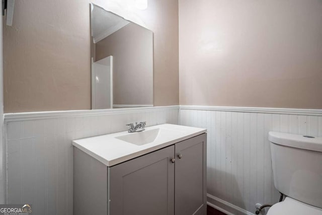 bathroom featuring vanity and toilet