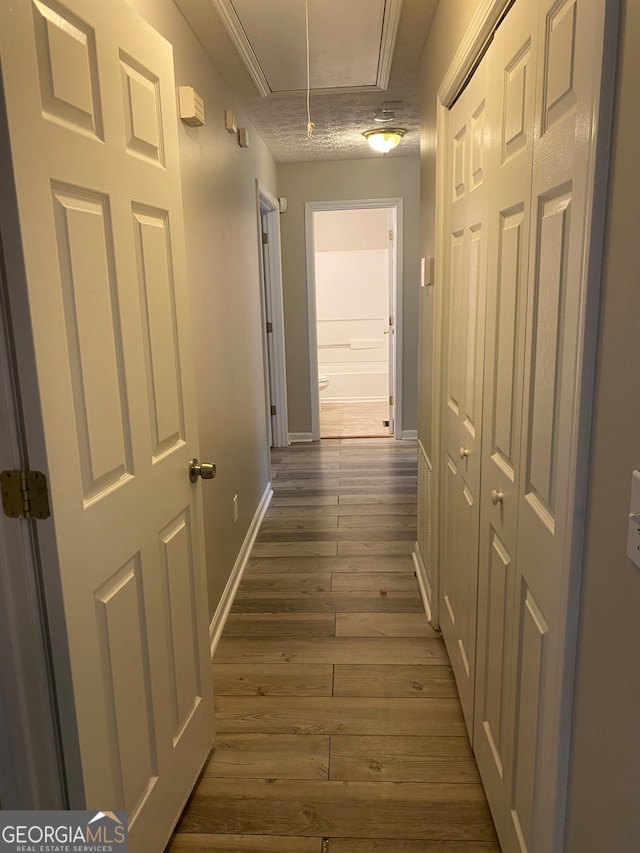 hallway featuring a textured ceiling and dark wood-type flooring