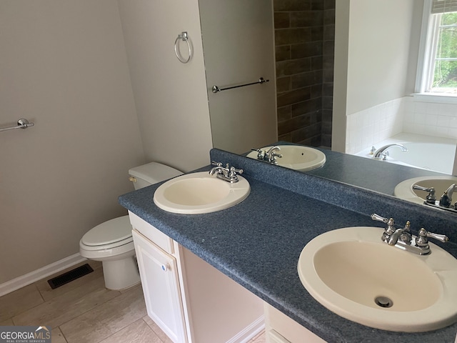 bathroom with vanity, toilet, hardwood / wood-style flooring, and a tub