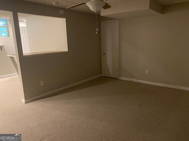 spare room with ceiling fan and carpet