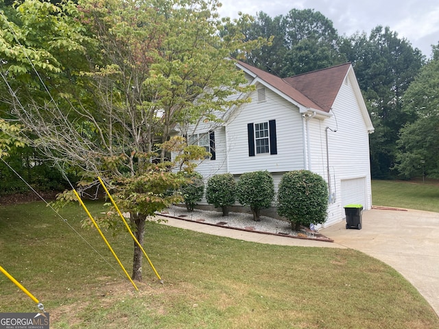 view of home's exterior with a lawn and a garage