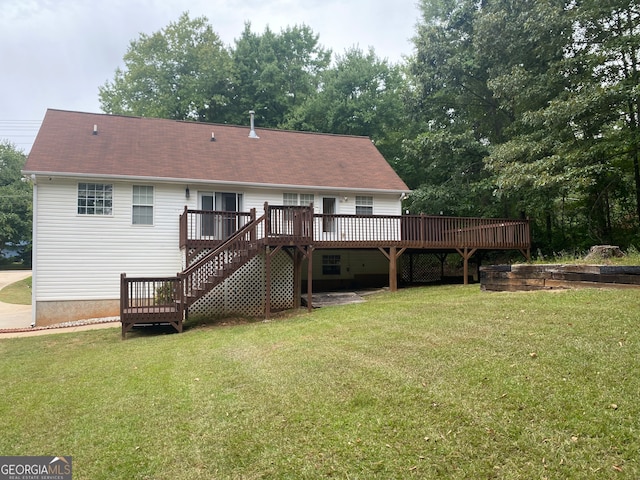 back of house featuring a wooden deck and a yard