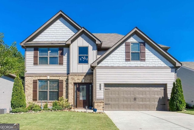 craftsman house featuring a garage and a front lawn