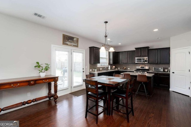 dining area with dark hardwood / wood-style flooring and sink