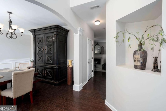 dining area featuring dark hardwood / wood-style floors and a chandelier