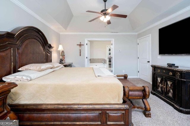 bedroom featuring light carpet, a tray ceiling, ceiling fan, connected bathroom, and ornamental molding